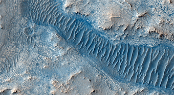 Layered Material Cut by a Valley Connected to East Jezero Crater